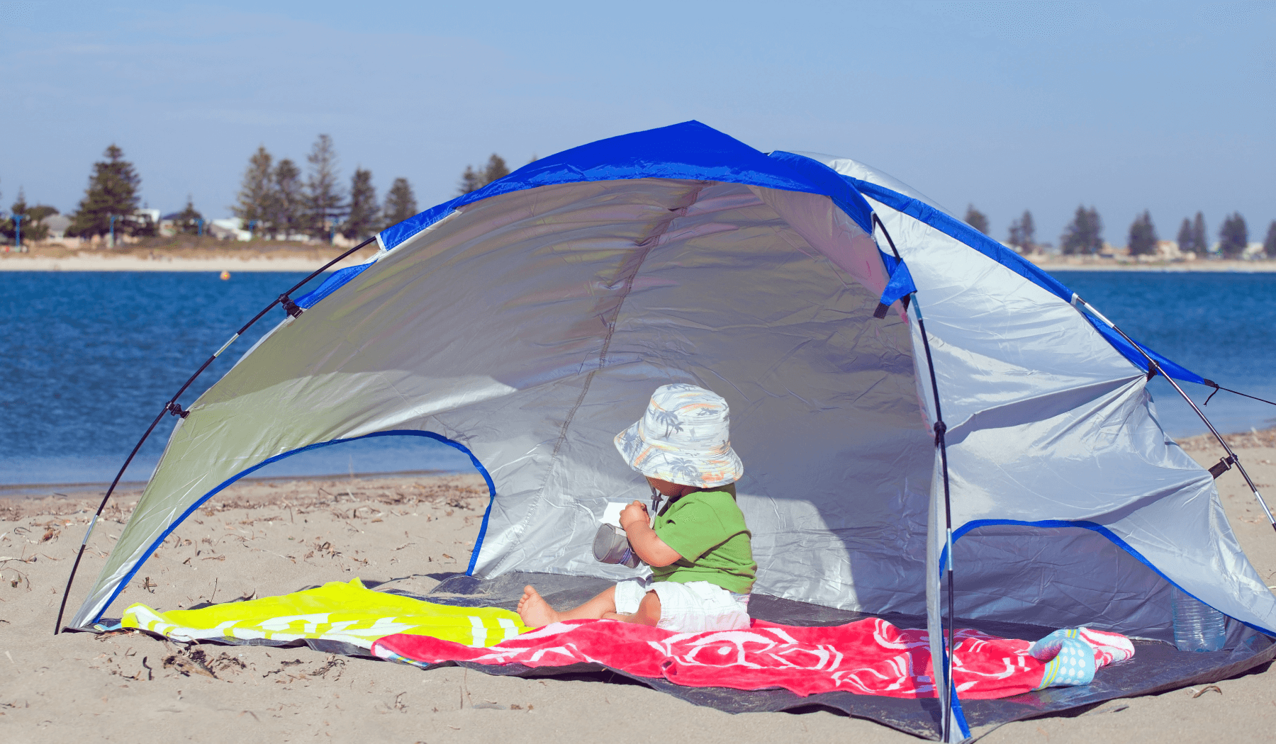 baby in the tent on the beach